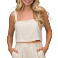 Woman wearing Tori Linen Tank in neutral color, front view showing comfort and breathable fabric design.