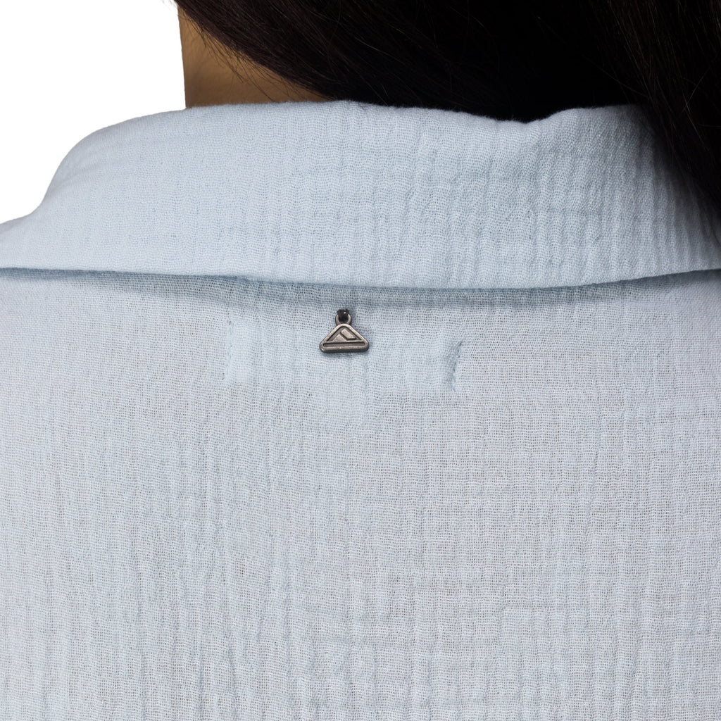 Close-up of the back collar of the Lainey Shirt Dress showing textured fabric and a small metal hanger detail.