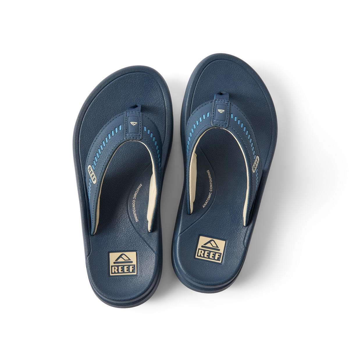 Pair of navy blue Cruiser flip flops for men, top-down view showing anatomically cushioned footbeds and arch support.