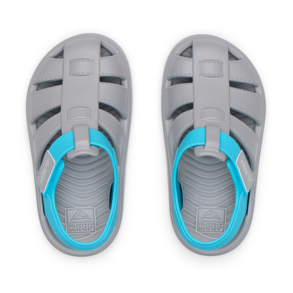 Top view of grey and blue Little Totally Beachin sandals for boys, featuring water-friendly durable material and cushioned footbeds.