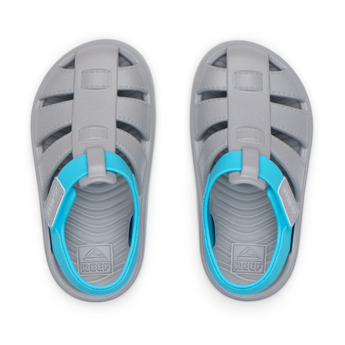 Top view of grey and blue Little Totally Beachin sandals for boys, featuring water-friendly durable material and cushioned footbeds.
