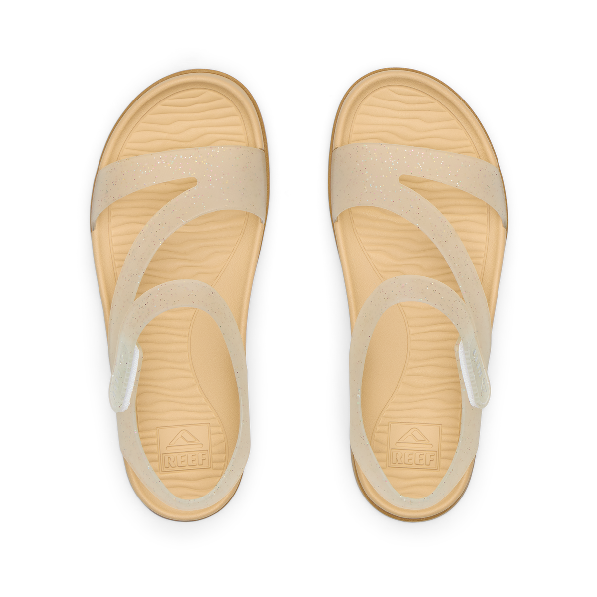 Top view of Kids Cali Coastin sandals for girls with glitter confetti straps and cushioned footbeds facing upward.