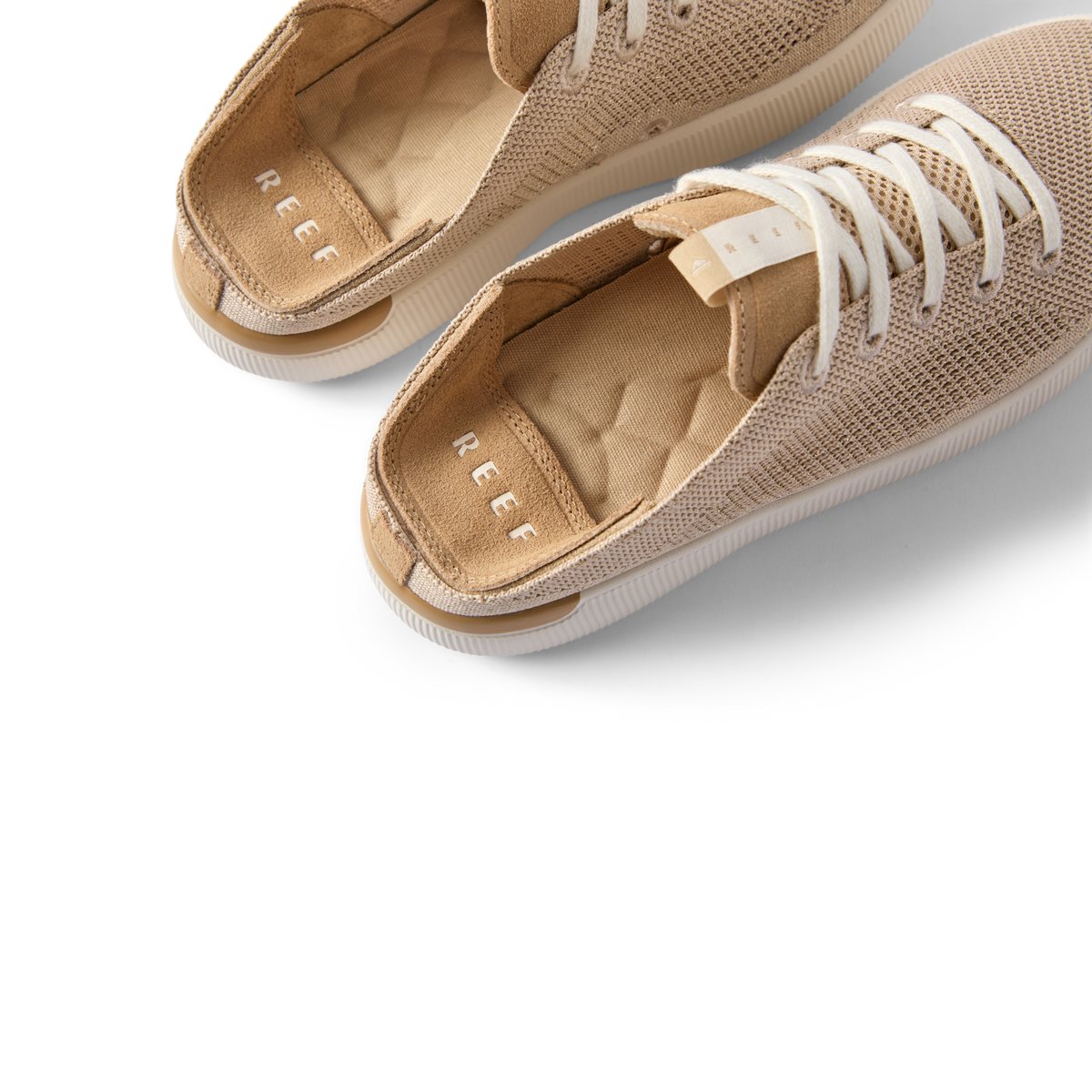 Reef Neptune women's shoes facing left with close-up on cushioned insoles and breathable knit upper in metallic gold.