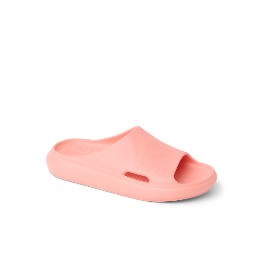 Kids Rio Slide coral-colored unisex footwear facing left, close-up of the top and side, with water-friendly, cushioned design.