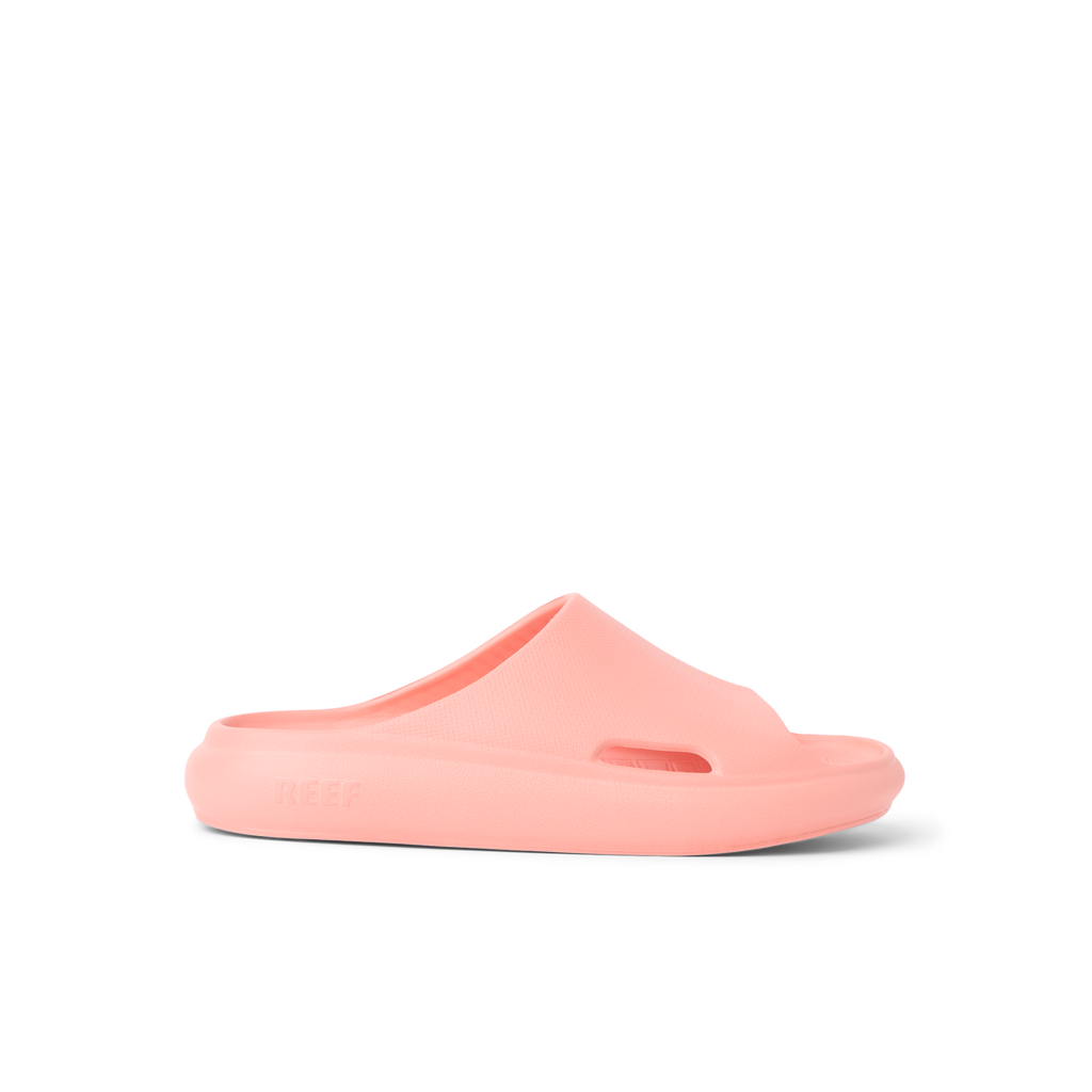 Kids Rio Slide coral-colored unisex slide facing right showing side profile with soft-rebound cushioning and arch support