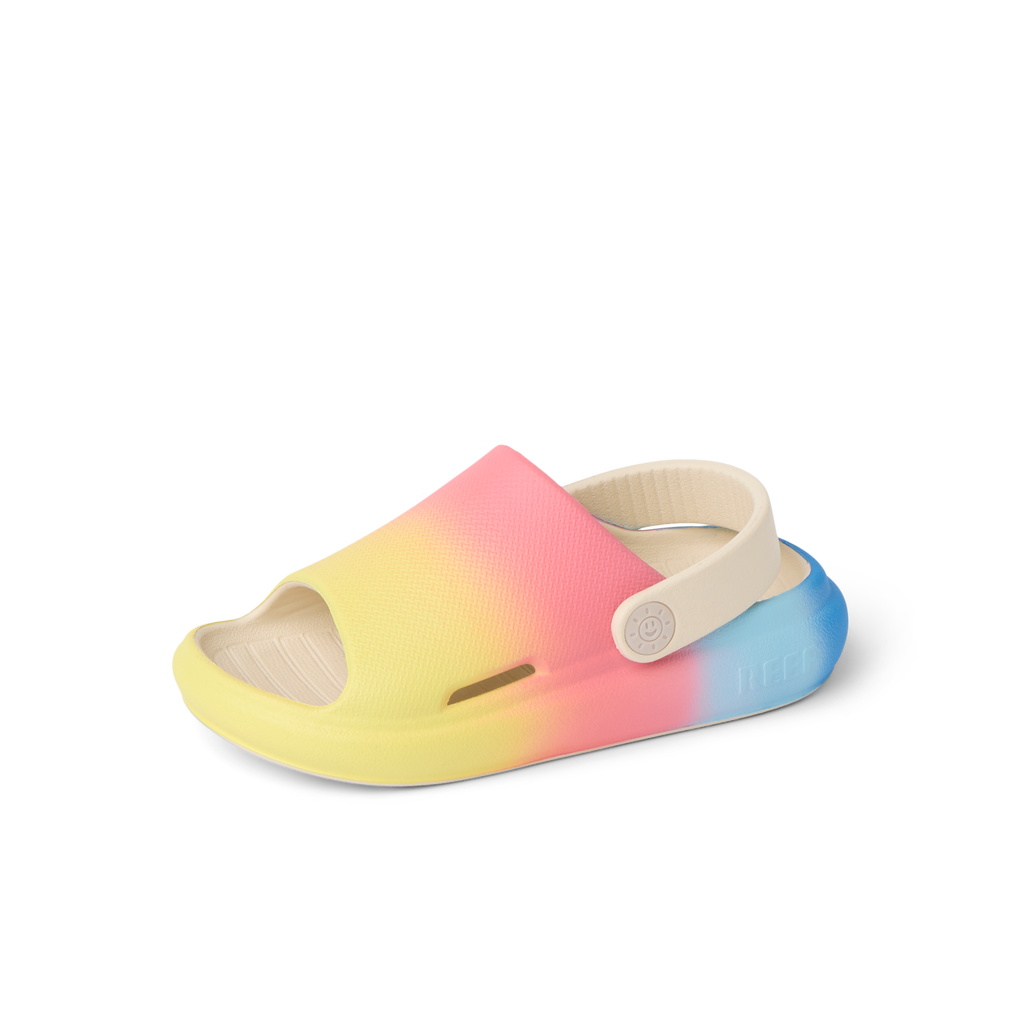 Little Rio Slide unisex toddler slide facing left with yellow, pink, and blue gradient, cushioned sole, and adjustable heel strap.
