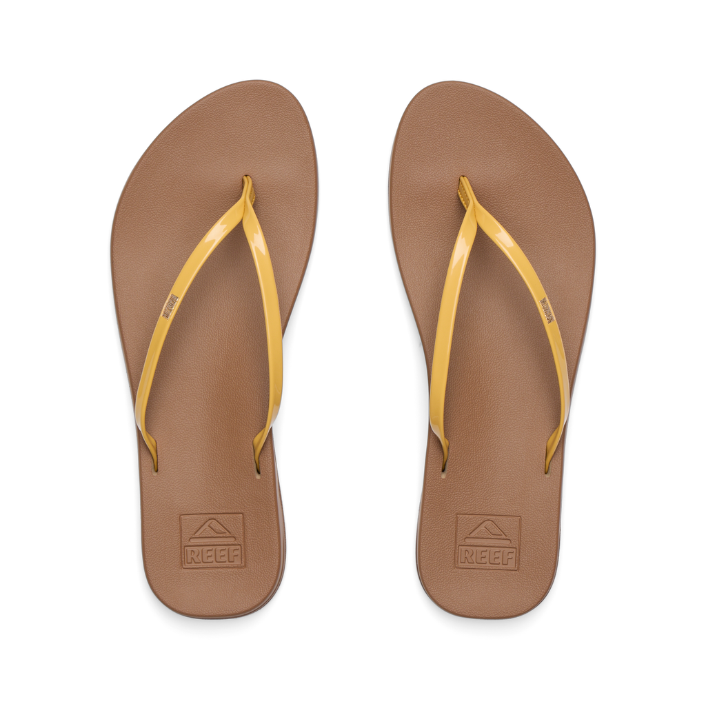 Top view of women's Cushion Slim sandals with golden apricot straps and brown footbeds, designed for beach comfort and support.
