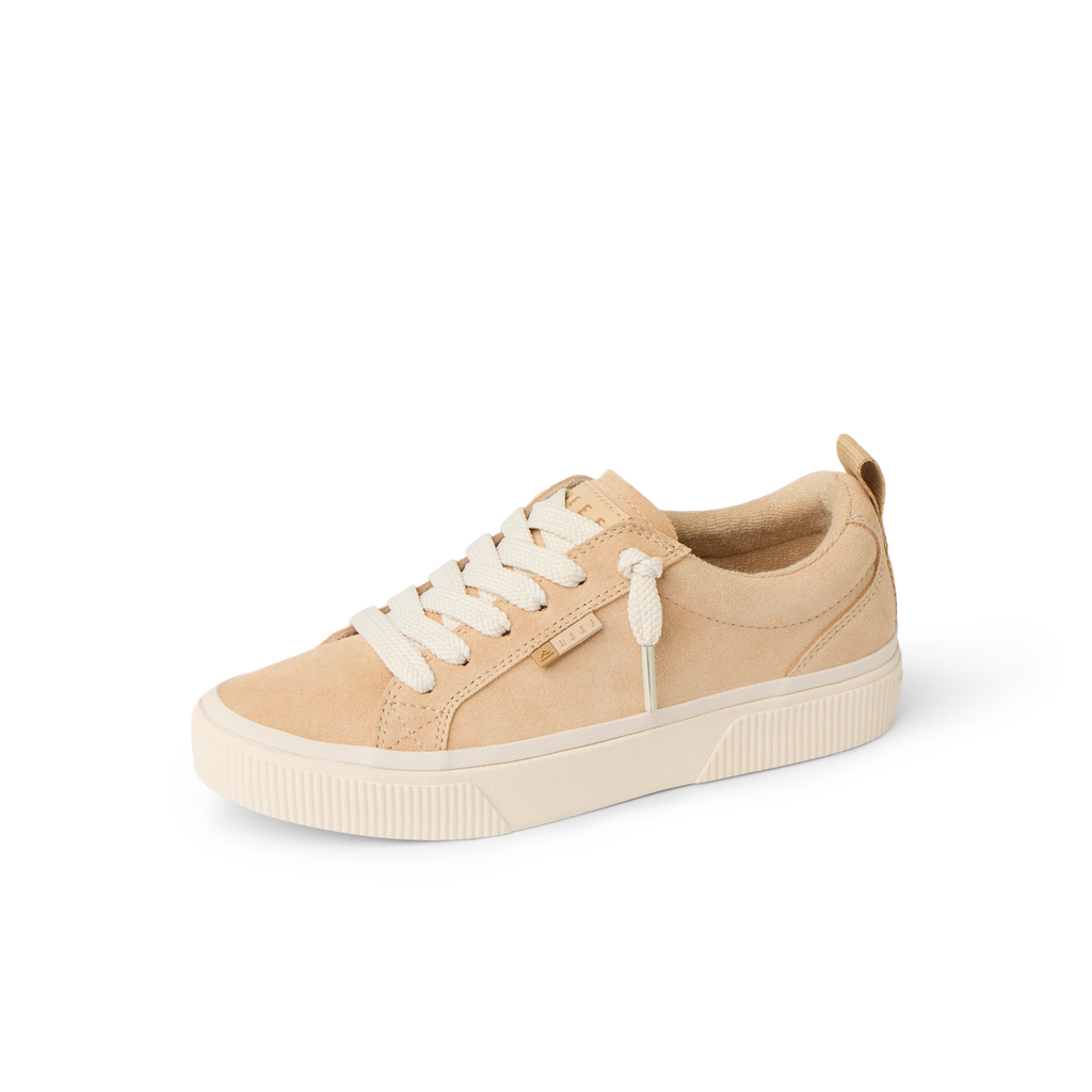 Lay Day Dawn women's tan sneaker facing left, featuring soft-rebound cushioning, anatomical arch support, and surf-inspired comfort.