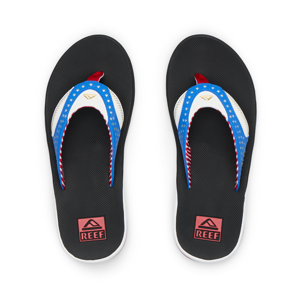 Pair of Fanning men's flip flops facing upward, featuring American flag design straps and cushioned soles for beach comfort.