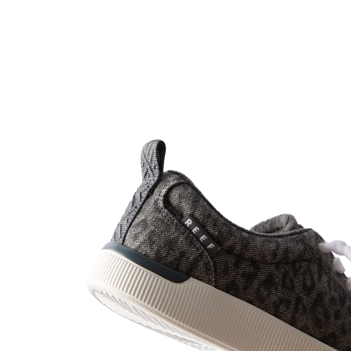 Neptune Alana women's shoe facing left, close-up of heel and side, featuring denim cheetah print and cushioned support.