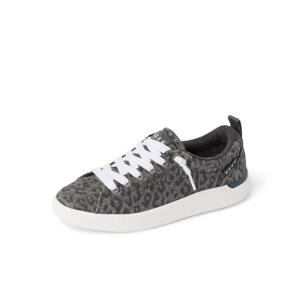 Neptune Alana women's sneaker facing left, close-up of front and side with cushioned sole and leopard print design.