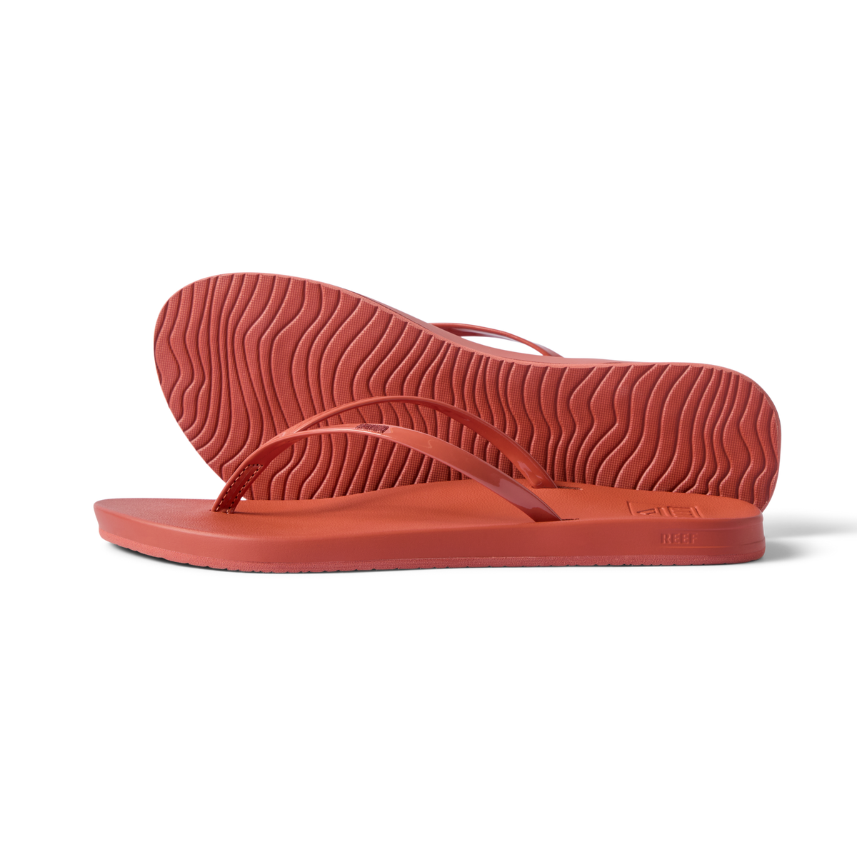 Side view of women's Cushion Slim flip flops in coral, showing sole and slim straps with arch support, water-friendly and comfortable.