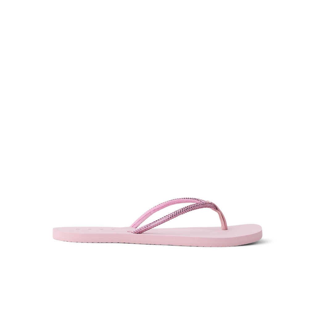 Bliss Bling Fling women's pink flip flop facing right, close-up of cushioned sole and textured straps for beach comfort
