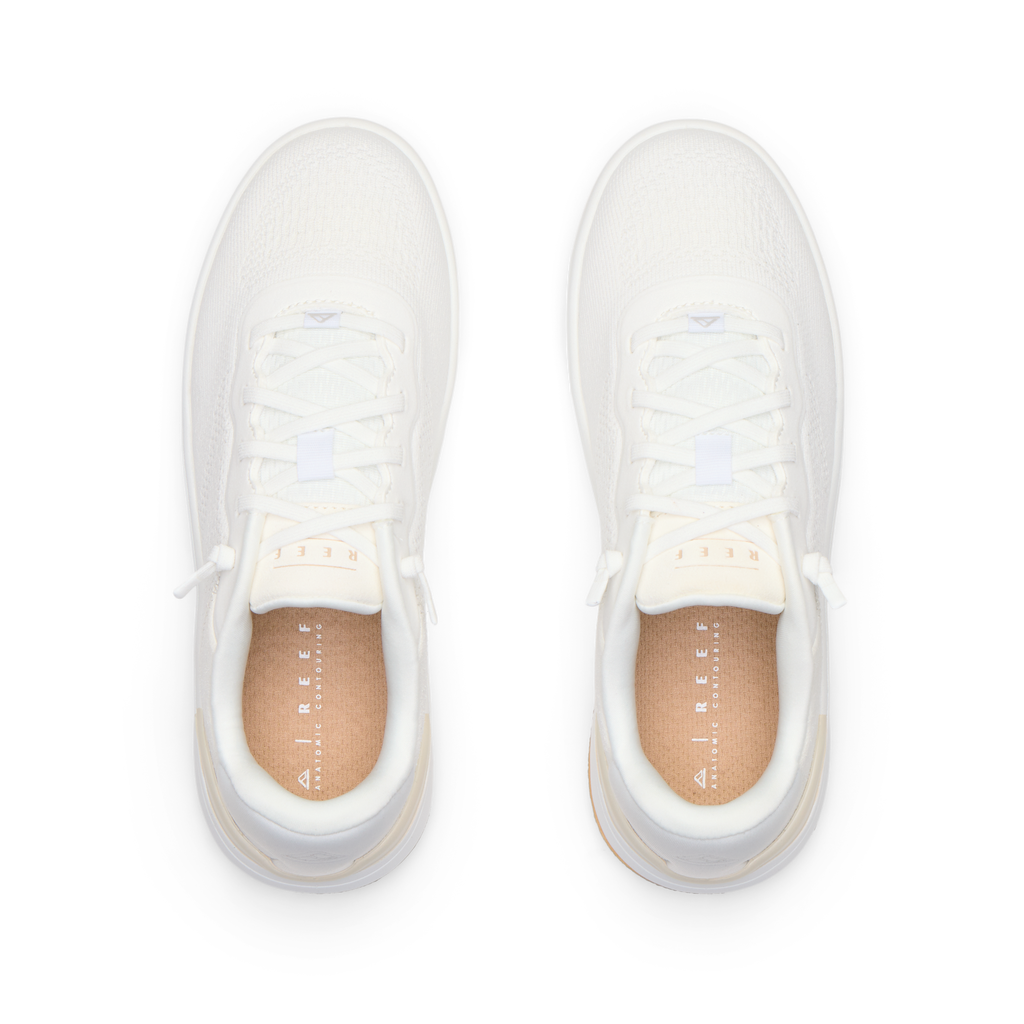 Top-down view of pair of white Reef Del Mar shoes featuring lightweight design and anatomical arch support for comfort.