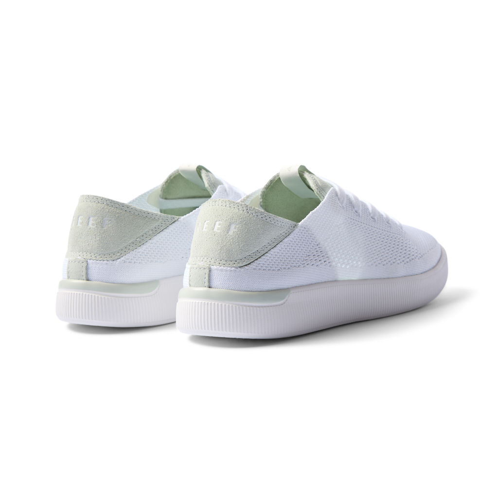 Reef Neptune women's sneakers showing rear and lateral sides facing left in white and dusty sage with cushioned arch support.