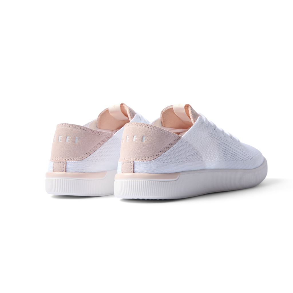 REEF Neptune women's white and blush sneakers facing backward showing heel with anatomical arch support and cushioning.