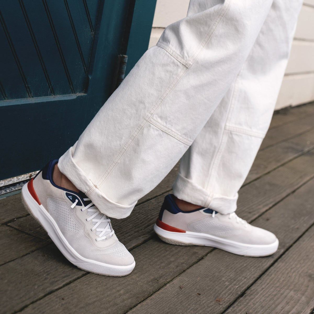 Pair of Shoreline Del Mar sneakers facing right, white with navy and tan accents, featuring cushioned sole and elastic laces.