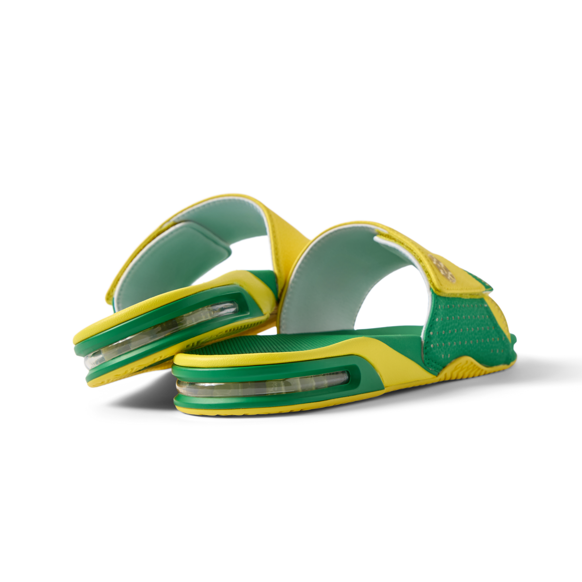 Pair of Fanning Slide sandals facing left, men's green and yellow water-friendly slides with cushioned EVA footbed and airbag heel.