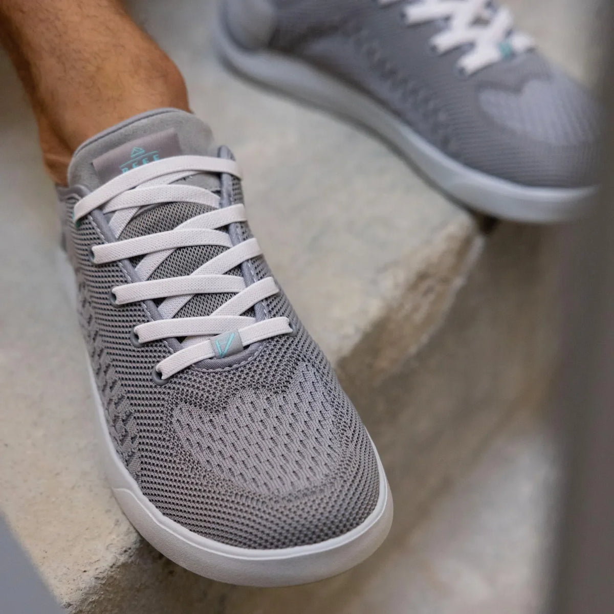 Neso shoe in grey facing forward, close-up on mesh upper and soft-rebound cushioned toe area for beach comfort.