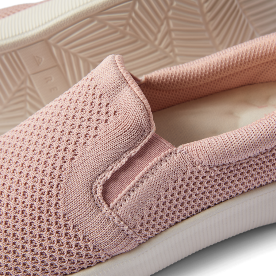 Close-up of the top and side of a pink Neptune Elyse slip-on shoe facing left, highlighting comfort and breathable design.