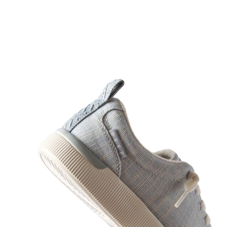 Close-up of the left side of Neptune Alana sneaker in blue textile, showing arch support and cushioned sole.