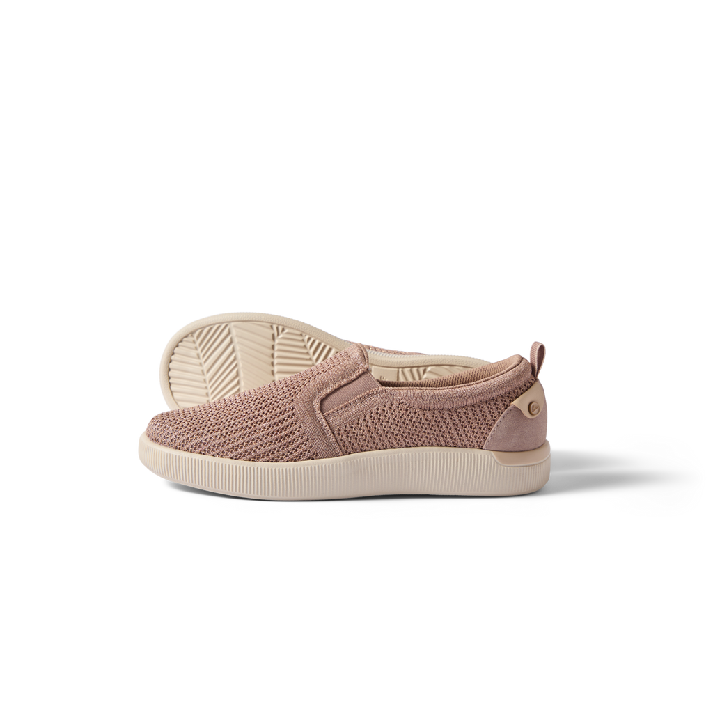 Neptune Elyse women's slip-on shoe facing right, showing side and sole with breathable knit upper in warm taupe.