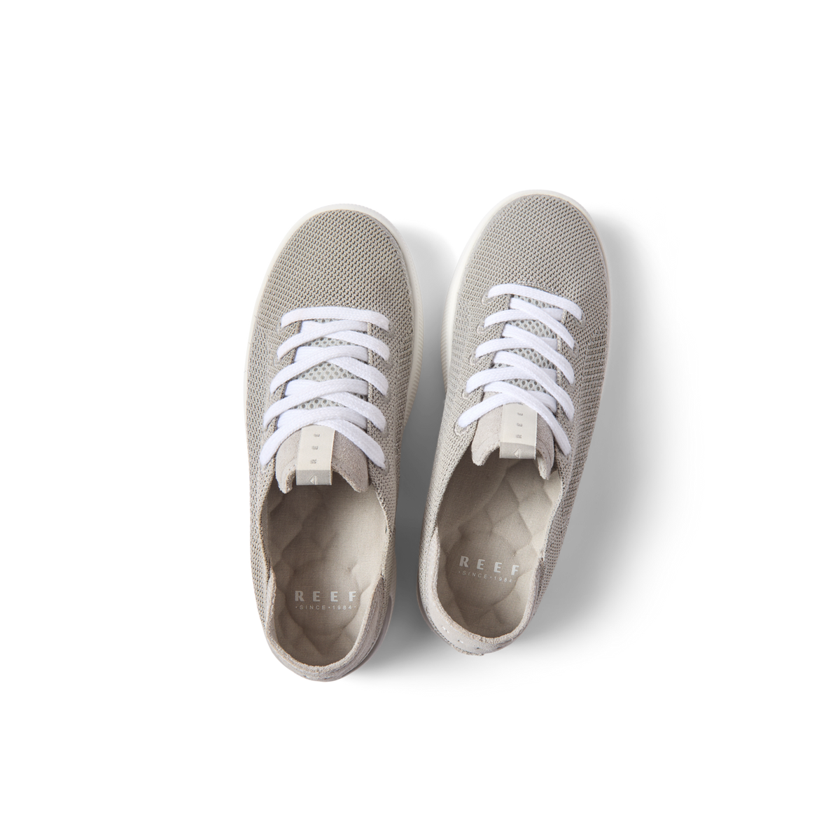 Top view of Reef Neptune women's lightweight sneakers in metallic silver with anatomical arch support and cushioning.