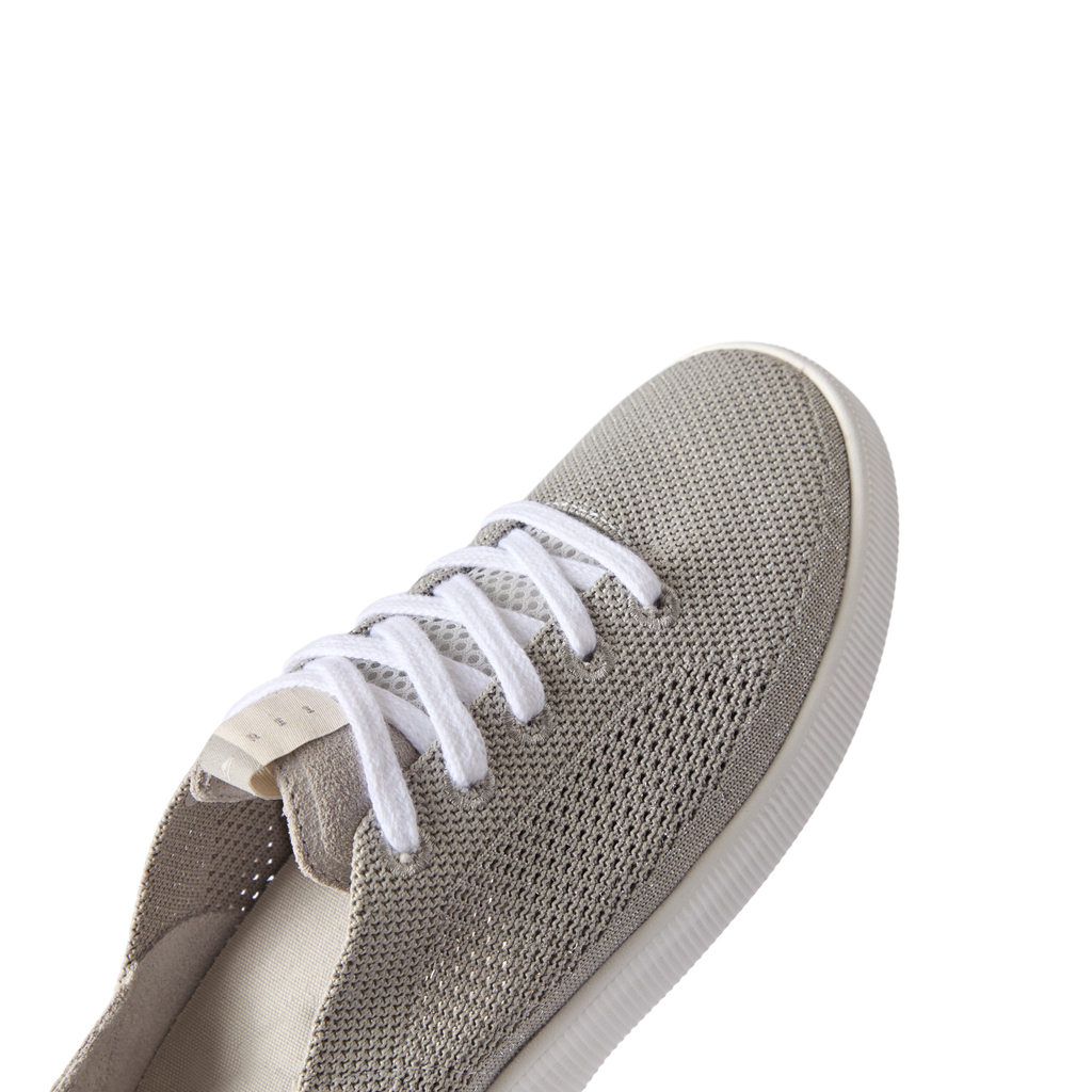 Reef Neptune women's sneaker facing forward, showing breathable knit upper with soft cushioning for beach comfort.