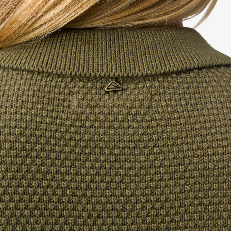 Up North Sweater Top showing olive textured knit fabric and ribbed collar from the back with small metal logo tag