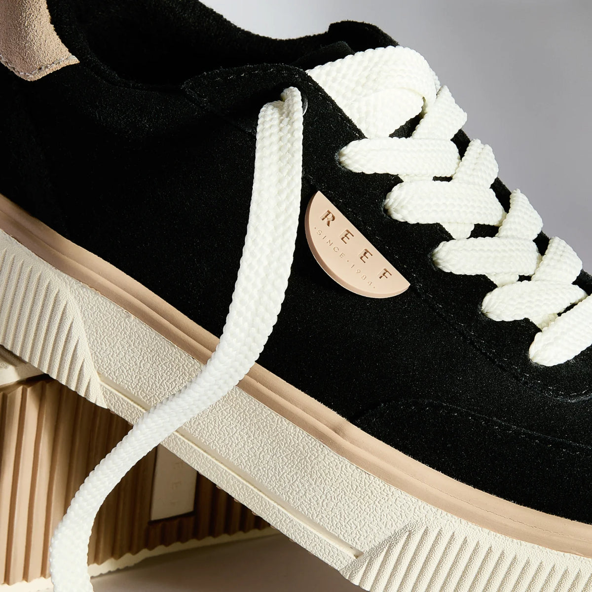 Close-up of the left side of Lay Day Lift sneaker facing right, featuring white laces and anatomical arch support.