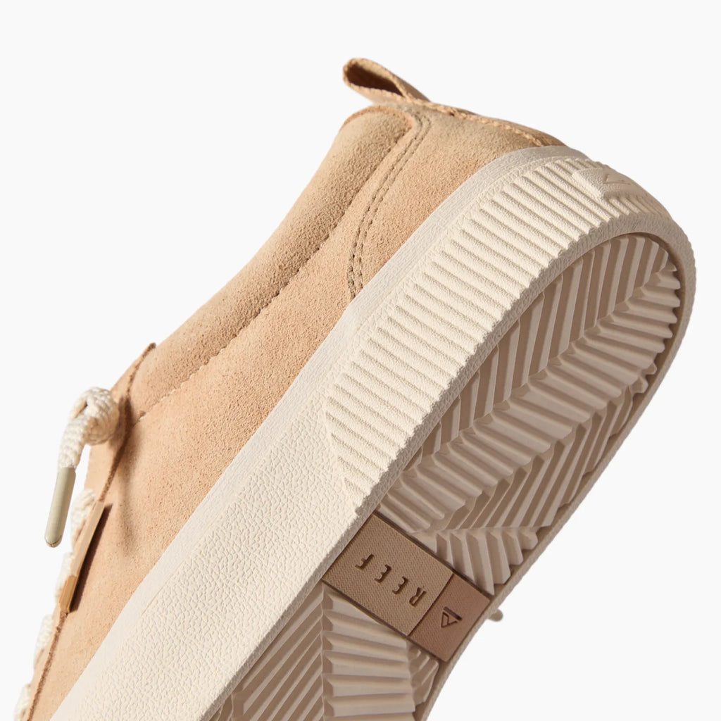 Lay Day Dawn shoe facing up, close-up of tan suede upper and textured sole with anatomical arch support, beach comfort design.