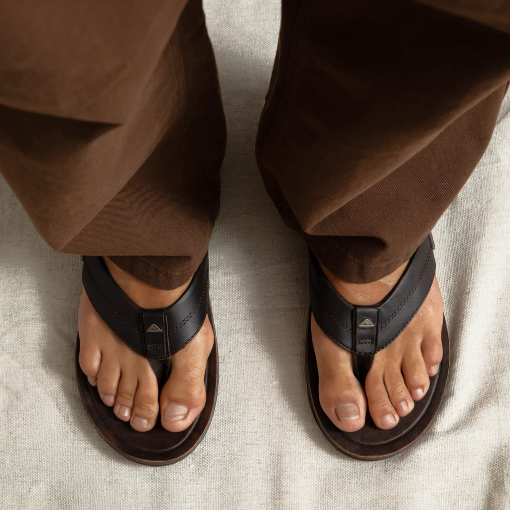 Top view of men's Leather Offshore brown leather sandals on feet, showing comfort-focused design and anatomical arch support.