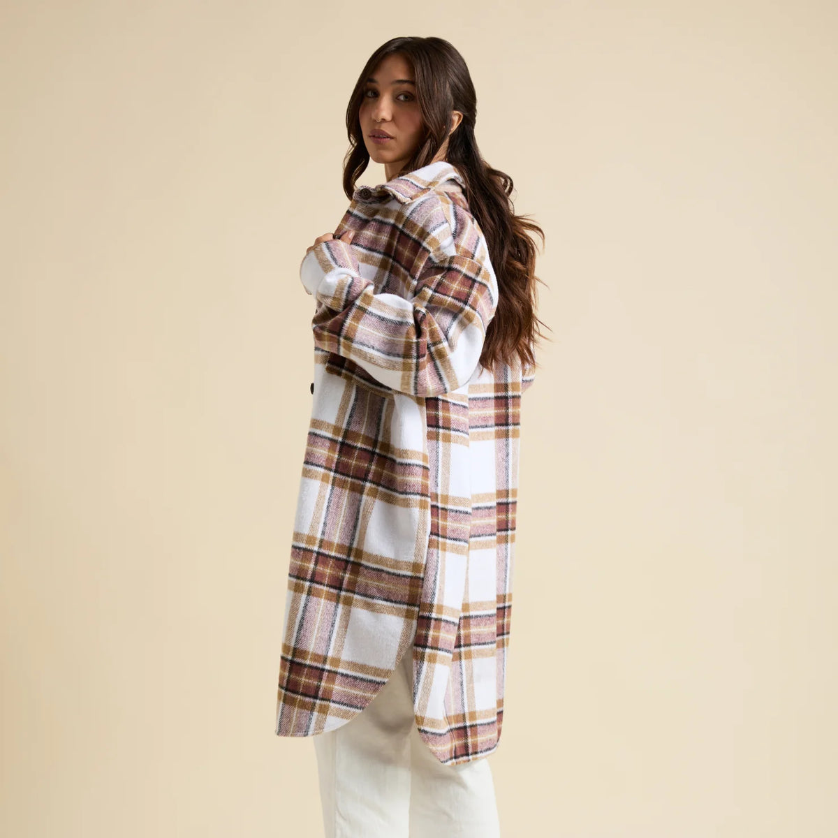 Woman wearing a Victoria Shacket in brown and white plaid, facing left, showing back and side with comfort-focused design.