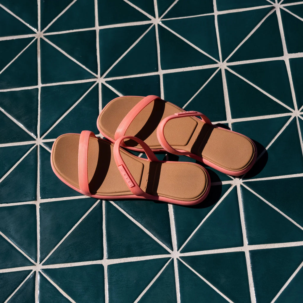 Water Willow Marina sandals facing upward with pink straps and molded footbeds on a geometric tiled surface