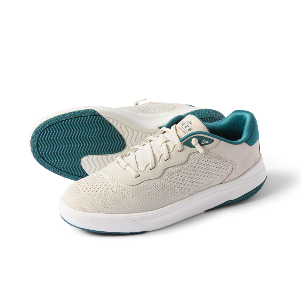 Pair of Shoreline Del Mar sneakers in off-white with teal accents, right shoe facing left showing side and sole details.