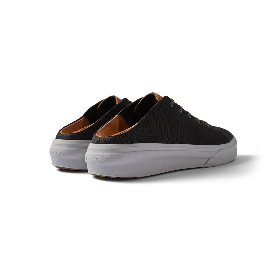 Atlantic men's black and tan sneakers facing backward, showing cushioned heel and durable sole for beach comfort.