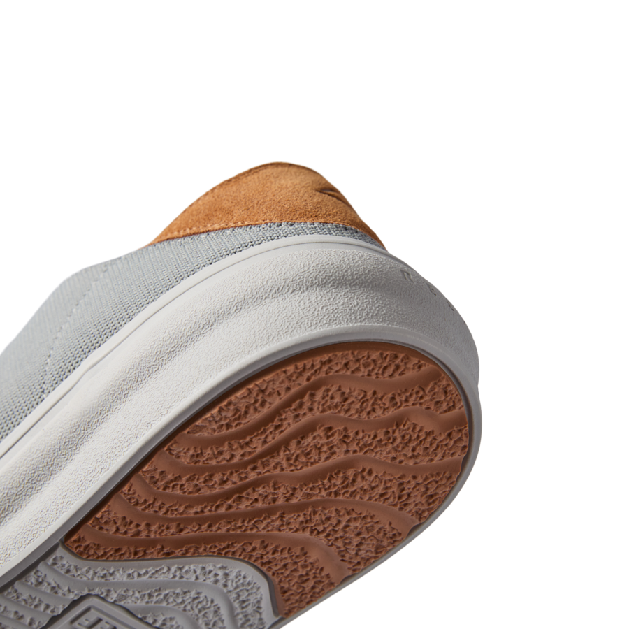 Atlantic men's shoe close-up of sole and heel facing upward with textured outsole, extra cushioning, and arch support design.