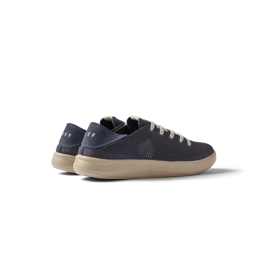 Neptune men's sneaker facing right, showing lateral side with soft-rebound cushioning and anatomical arch support in navy.