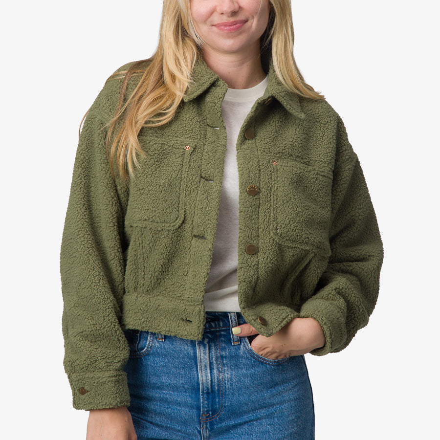 Woman wearing olive green Sammie Sherpa Jacket front view with comfort-focused, surf-inspired design details.
