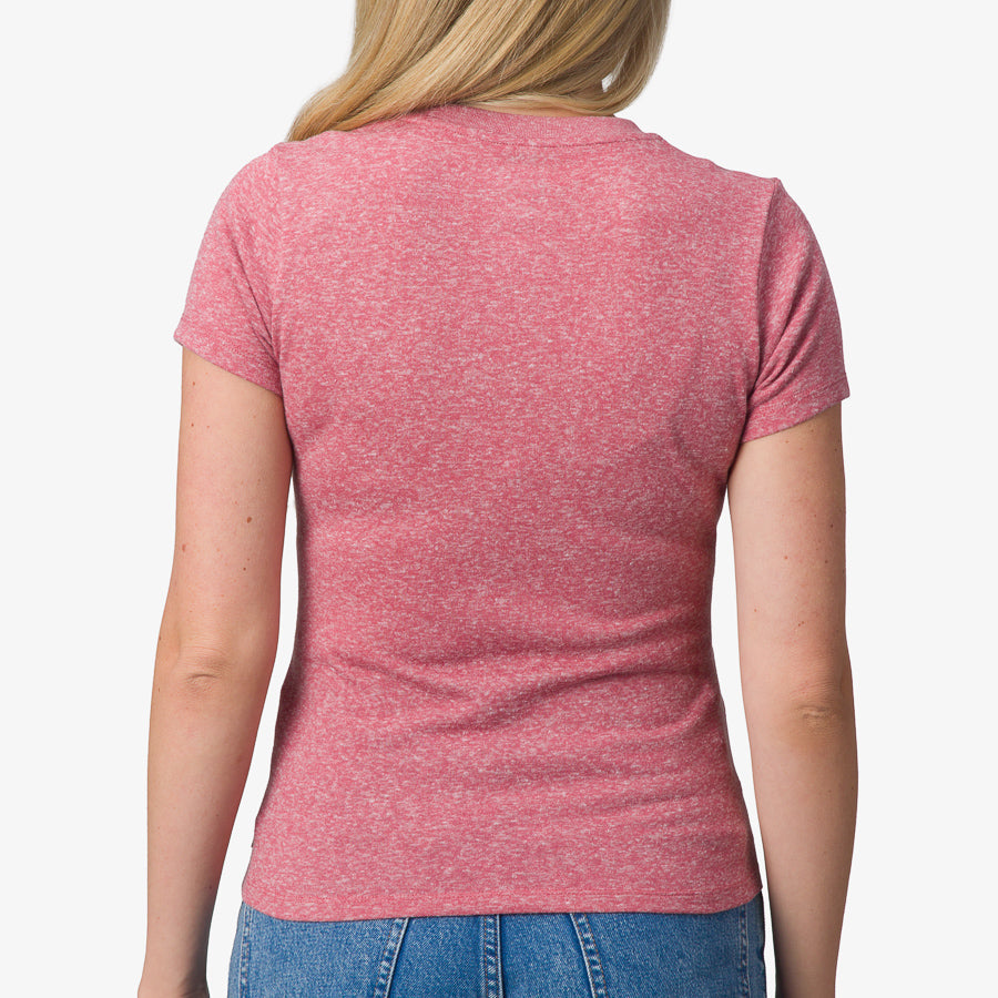 Woman wearing a mauve Saylor Fitted Tee showing the back, highlighting comfort and beach-inspired apparel.