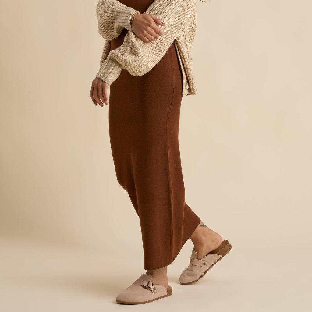 Vista Serenity women's left foot shown in side view wearing beige suede comfort footwear with arch support and soft cushioning.