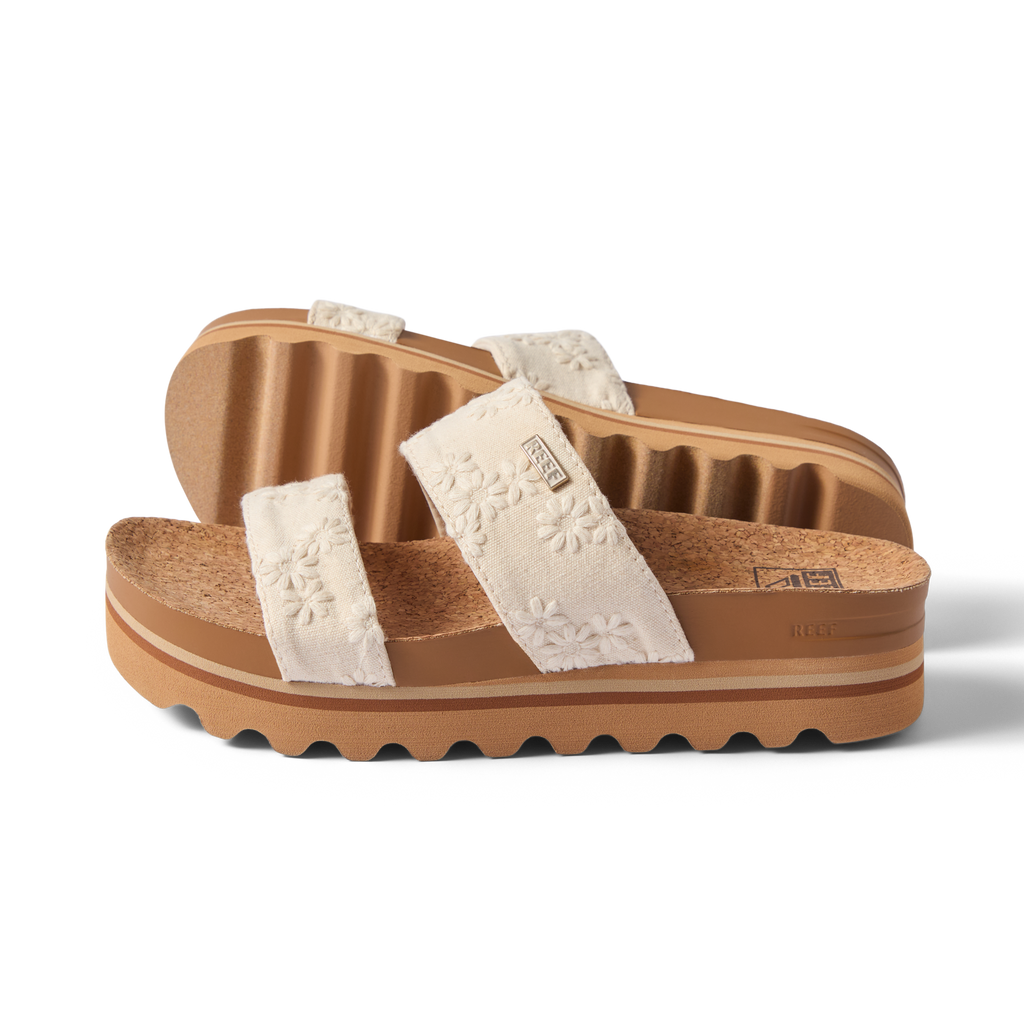 Side view of Cushion Vista Hi women's sandals with floral embroidered straps and cork footbed on ridged sole