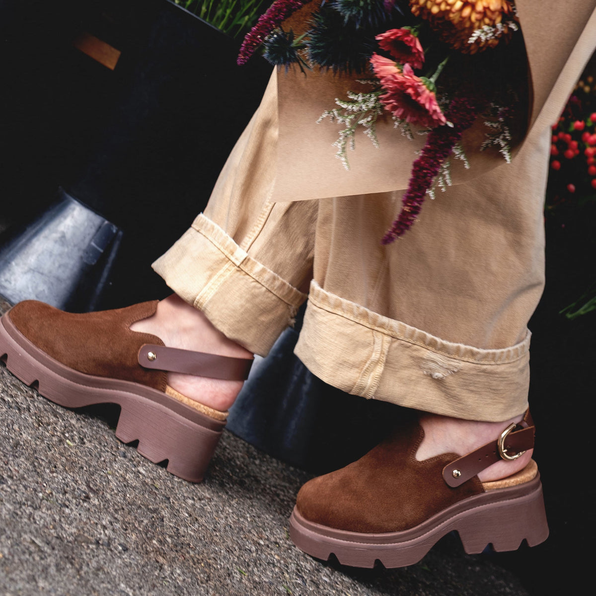 Vista Luxe Solene brown suede platform clog facing right, showing adjustable buckle strap and thick sole, close-up heel view.
