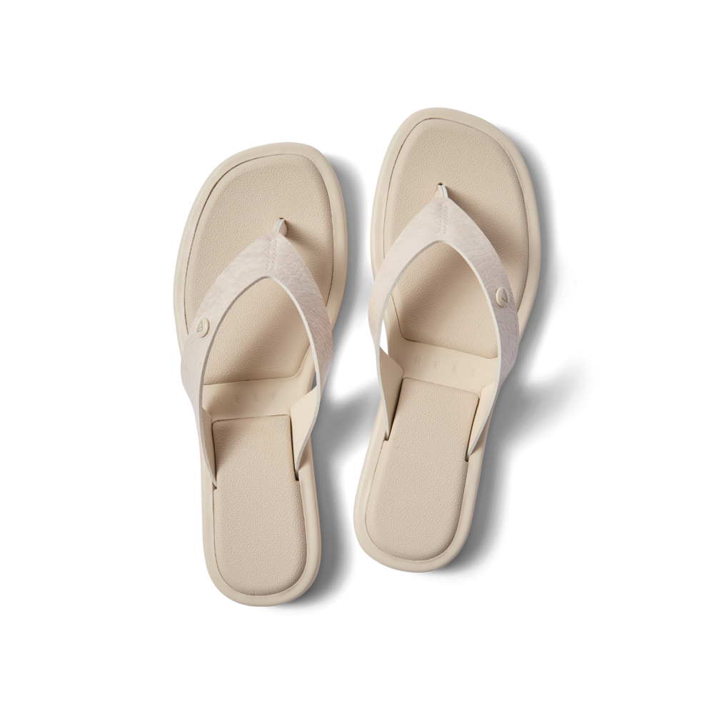 Willow Ella women's white flip flops facing upward, beach-inspired with soft cushion and arch support for comfort.