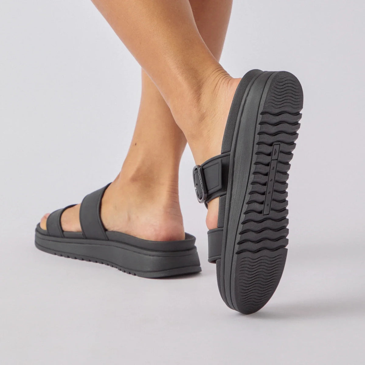 Vista Capri women's black sandals facing backward showing textured sole, surf-inspired comfort and durability features.